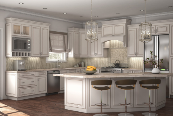 A large, open-concept kitchen with white cabinetry, stainless steel appliances, and a central island with seating. The room features a neutral color palette, crystal chandeliers, and views of the outdoors through large windows