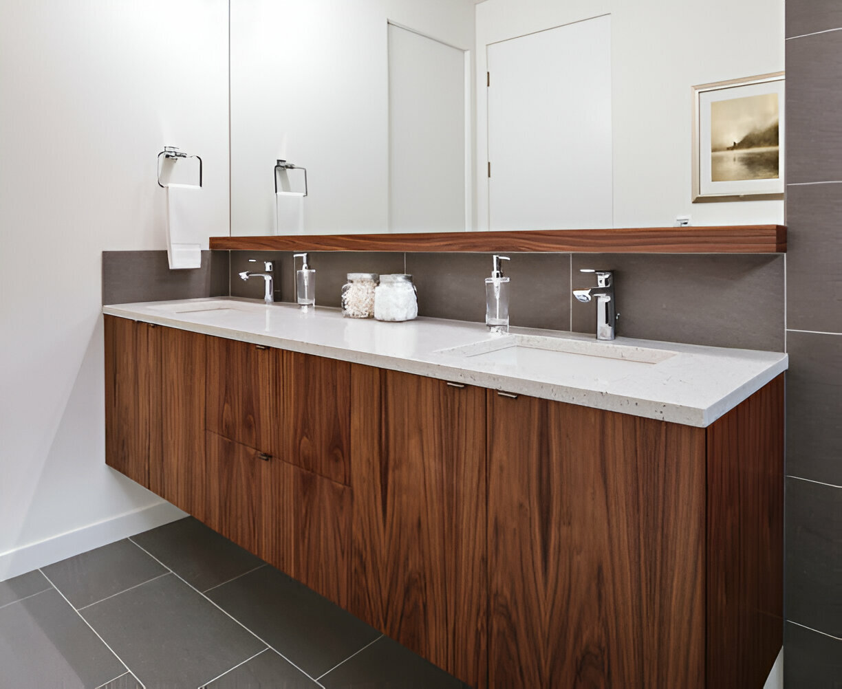 Floating walnut double vanity with a white quartz countertop, undermount sinks, and polished chrome faucets in a modern bathroom