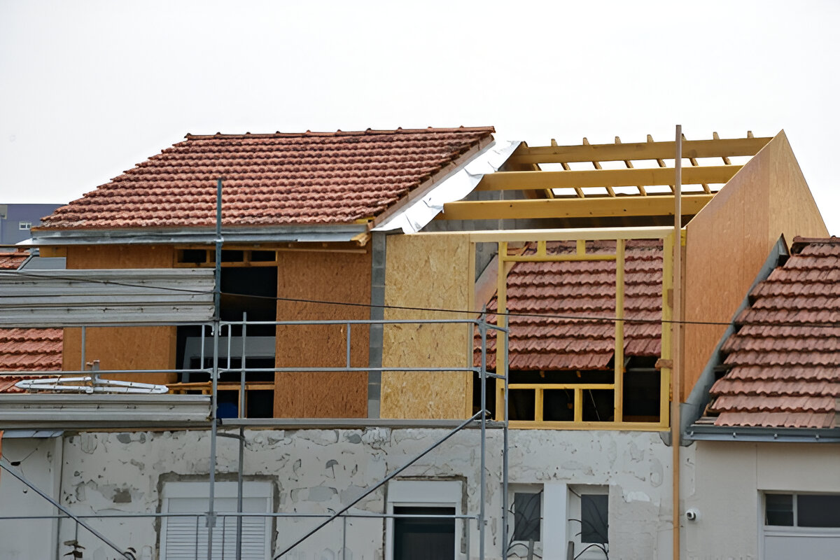 Residential home undergoing second-story roof extension construction
