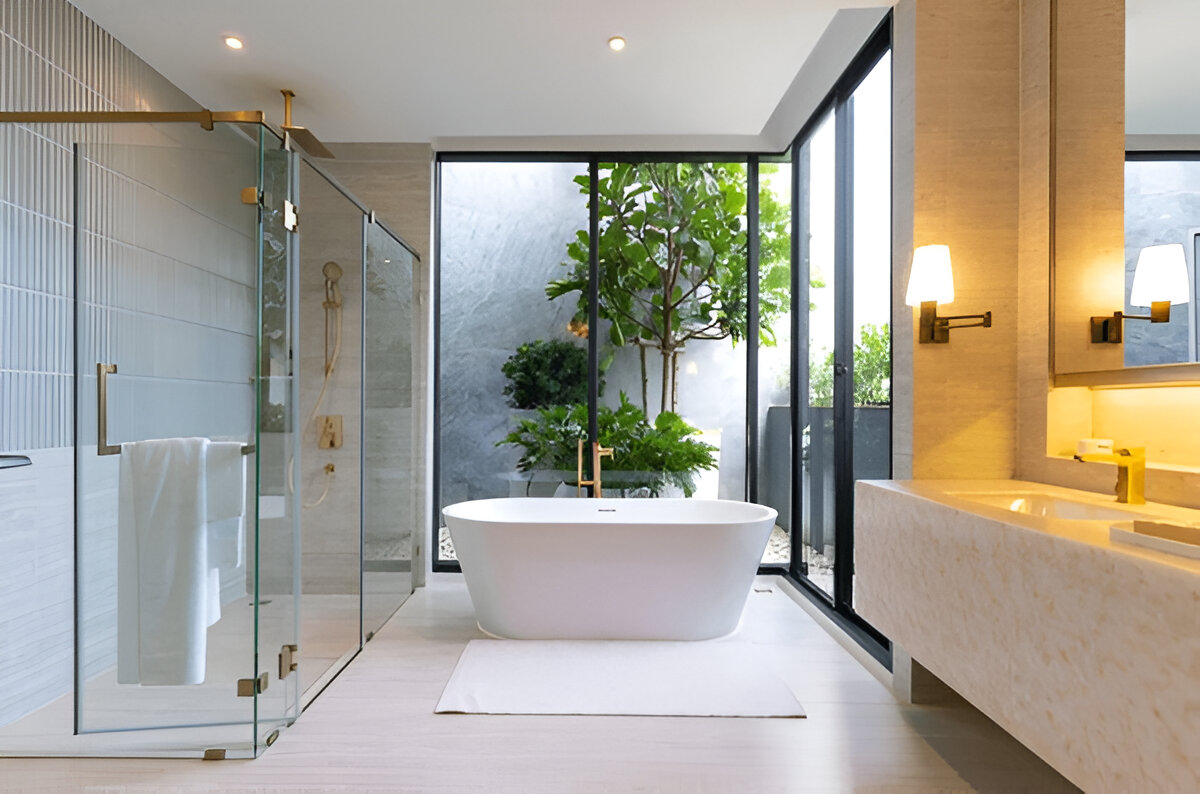 Modern bathroom with freestanding tub and glass shower enclosure 