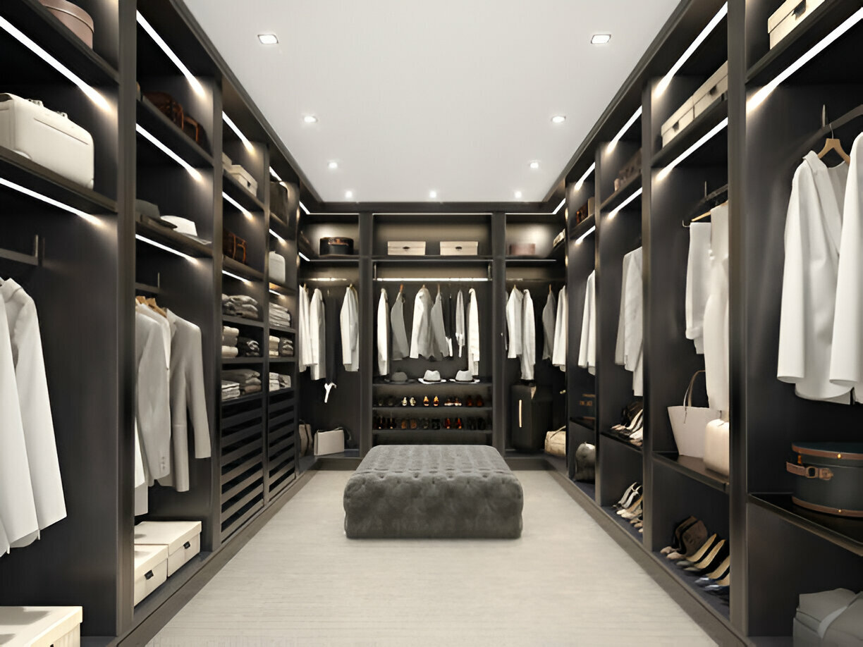 Modern luxury walk-in closet with dark wood cabinetry