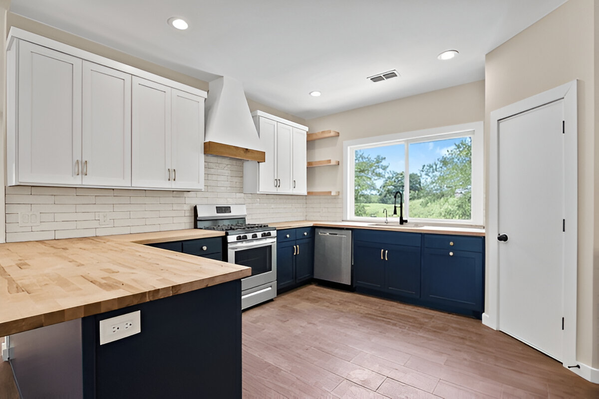 Modern kitchen with navy lower cabinets and white upper cabinets