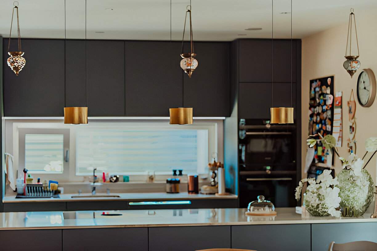 Stylish kitchen with matte black cabinets, gold pendant lights, and floral decor