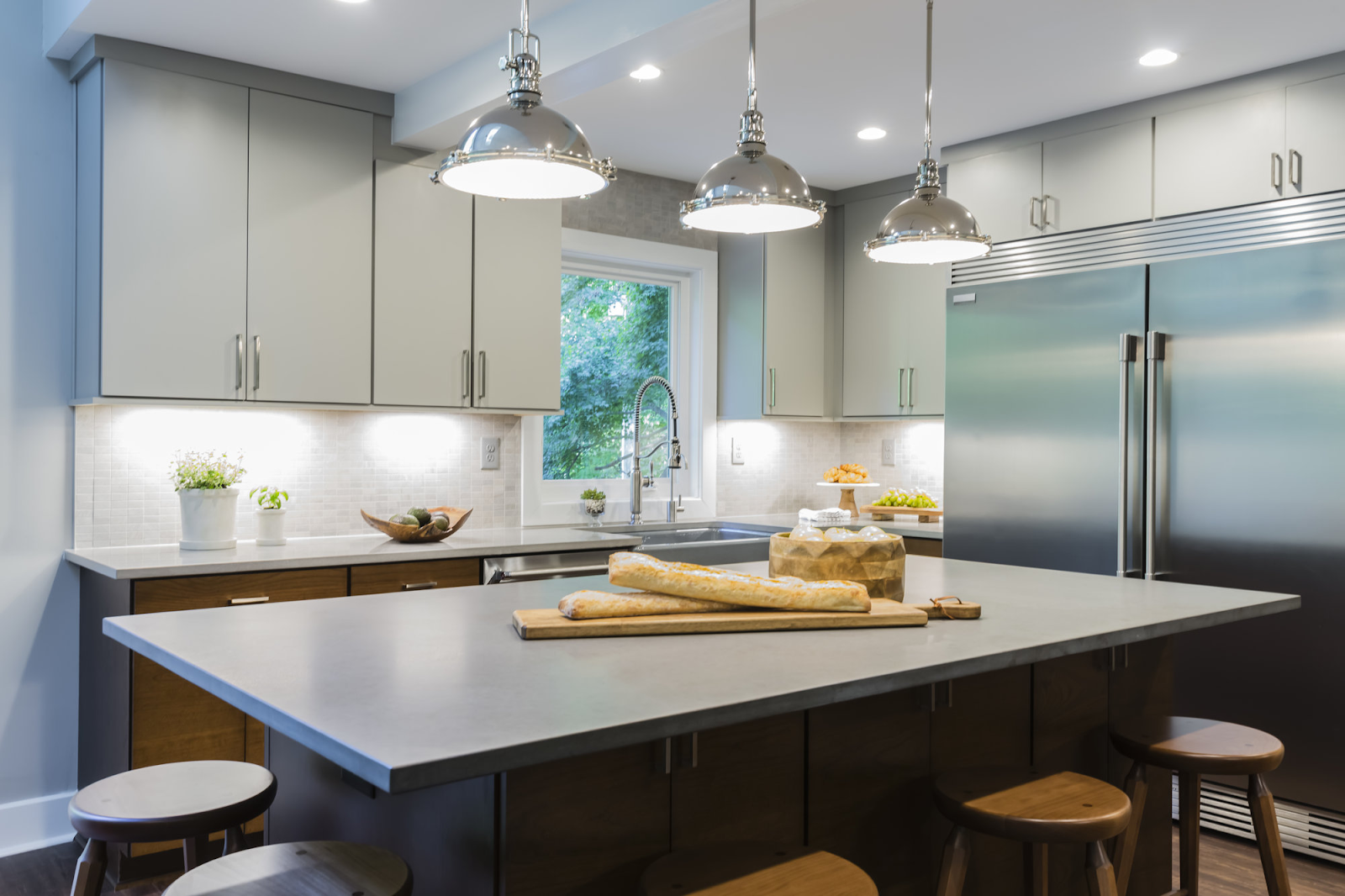 Modern kitchen with matte quartz countertops and industrial pendant lights