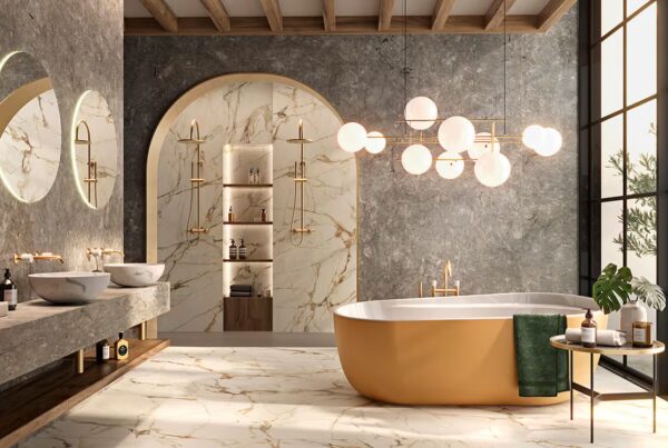 Luxurious bathroom featuring a freestanding bathtub, gold finish taps and fittings, marble wall accents, and classic decor elements