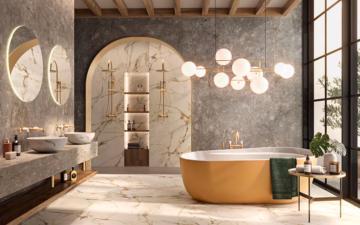 Luxurious bathroom featuring a freestanding bathtub, gold finish taps and fittings, marble wall accents, and classic decor elements