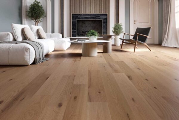 Spacious living room featuring light oak hardwood flooring, white modular sofa, round coffee tables, and arched doorway design