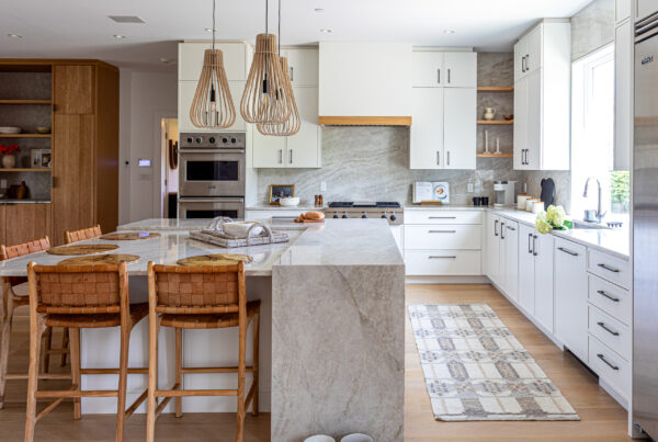 Modern white kitchen with marble island and natural wood accents
