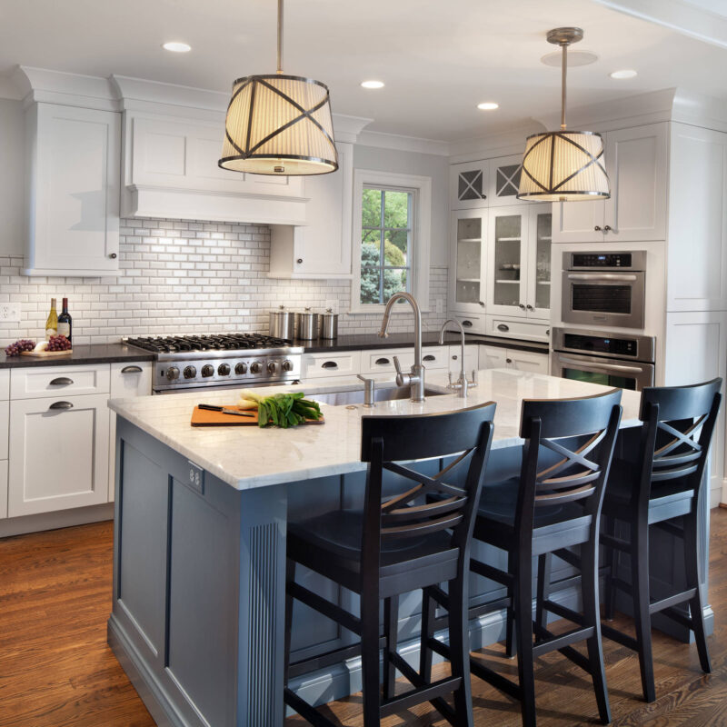 Bright transitional kitchen with white cabinetry, subway tile backsplash, and a blue island